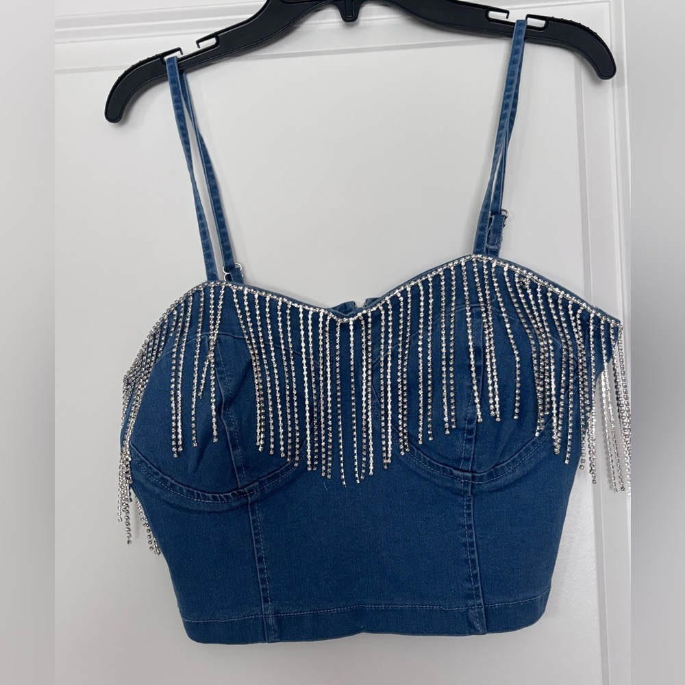 Cropped denim look top with spaghetti straps and rhinestone fringe. Size M